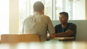 Man getting marketing advice from those who have been where he is now